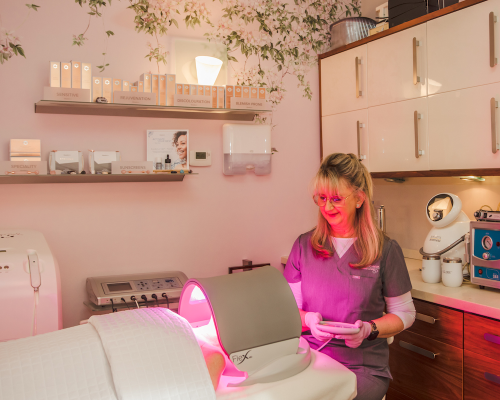 Debbie treats a client with Dermalux LED Phototherapy